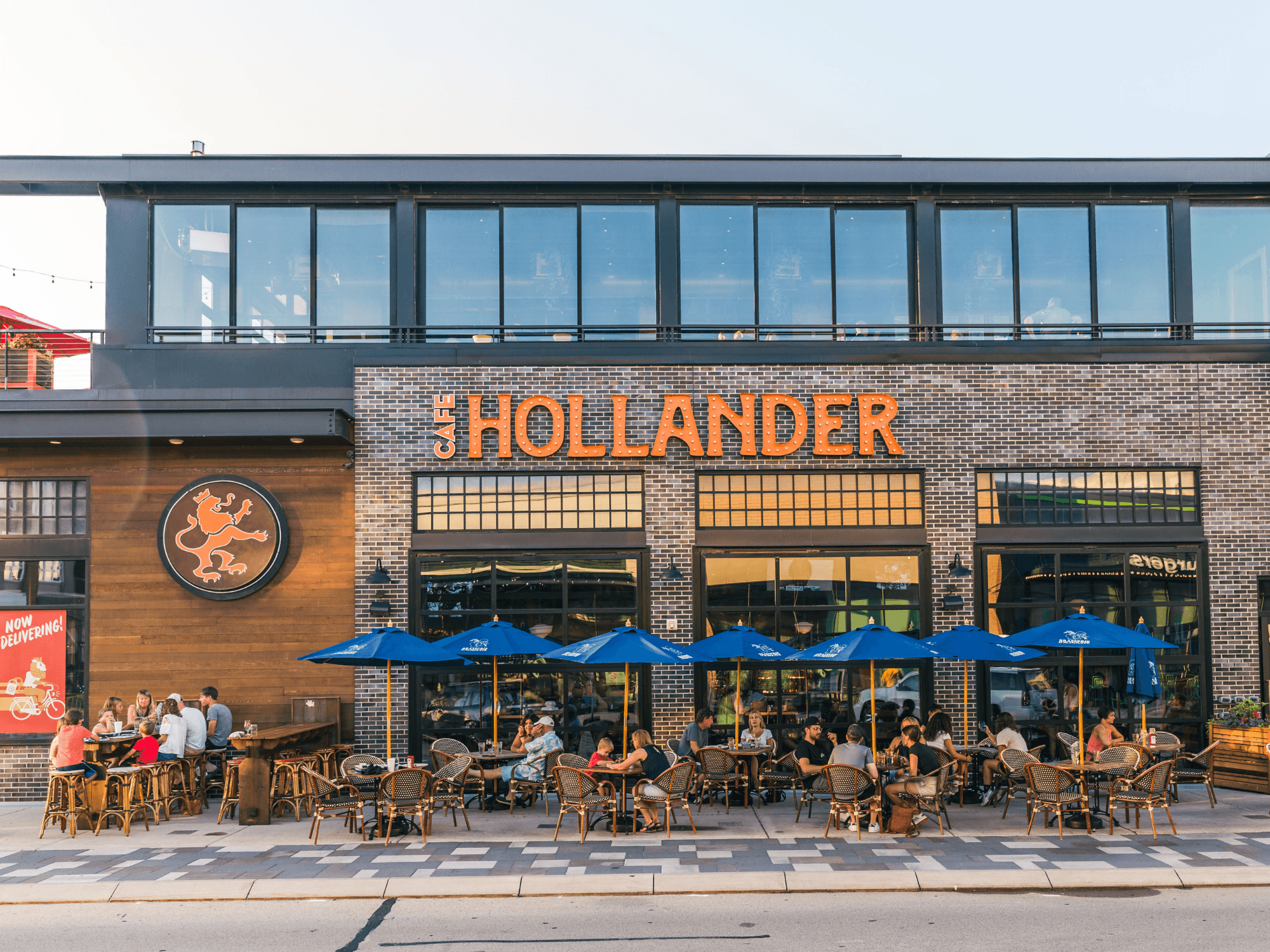 the outside of Cafe Hollander with a full porch full of people dining.